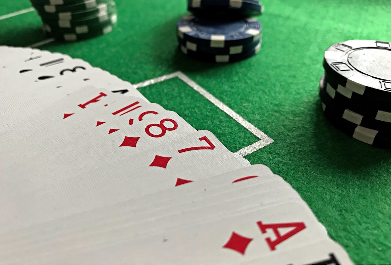 services-02 Close-up view of poker cards and chips on a green felt table, perfect for casino-themed content.