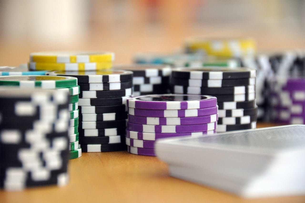 services-05 A close-up shot of stacked poker chips and playing cards on a table, perfect for casino and gambling themes.